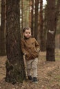 Adorable little boy hiking in the forest on summer day