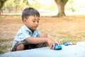 Cute little boy play toy car in the green park Royalty Free Stock Photo