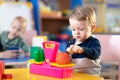 Cute little boy playing with abacus in nursery. Preschooler having fun with educational toy in daycare or creche. Smart Royalty Free Stock Photo