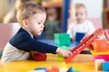 Cute little boy playing with abacus in nursery. Preschooler having fun with educational toy in daycare or kindergarten Royalty Free Stock Photo