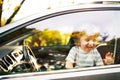 Little boy in the car, looking out of window, waving. Royalty Free Stock Photo