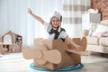 Cute little boy playing with cardboard airplane Royalty Free Stock Photo