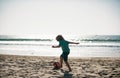 Cute little boy playing football with foot ball on sandy beach. Summer kid sport. Royalty Free Stock Photo