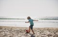 Cute little boy playing football with foot ball on sandy beach. Summer kid sport. Royalty Free Stock Photo