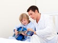Cute little boy playing guitar with his father Royalty Free Stock Photo
