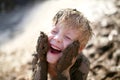 Cute Little Boy Playing Outside in the Mud with a Dirty Face