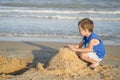 Cute little boy playing with sand on tropical beach Royalty Free Stock Photo