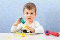 Cute little boy is playing with tools. A toddler working with toy tools. Royalty Free Stock Photo