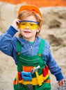 Cute little boy playing with toy tools and smiling at camera. Child 5 year old pretend to civil engineer. Kid wearing Royalty Free Stock Photo