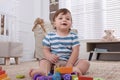 Cute little boy playing with toys in room at home Royalty Free Stock Photo