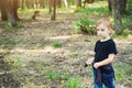 Cute little boy playing on wild nature. Family vacations on countryside. Happy childhood. Happy kid walking in summer forest. Happ