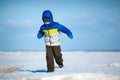 Cute little boy playing on winter beach Royalty Free Stock Photo