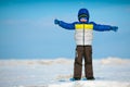 Cute little boy playing on winter beach Royalty Free Stock Photo