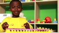 Cute little boy playing xylophone in classroom