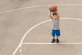 Cute little boy practising on a basketball court Royalty Free Stock Photo