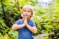 Cute little boy praying in the woods Royalty Free Stock Photo