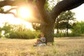 Cute little boy reading book near tree Royalty Free Stock Photo