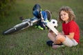 Cute little boy reading book in park. Kid sit on grass and reading book. Kid boy reading interest book in the garden Royalty Free Stock Photo