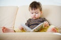 Cute little boy reading book on sofa Royalty Free Stock Photo