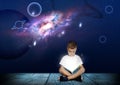 Cute little boy reading magic book. Night sky with stars and planets Royalty Free Stock Photo