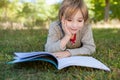 Cute little boy reading in park Royalty Free Stock Photo