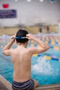Cute little boy ready to dive in the sport swimming pool.Indoors. Sport activities for children.Training for competition Royalty Free Stock Photo