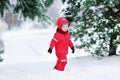 Cute little boy in red winter clothes having fun with snow Royalty Free Stock Photo