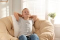 Cute little boy relaxing in papasan chair Royalty Free Stock Photo