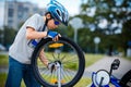 Cute little boy repairing bicycle outdoors Royalty Free Stock Photo