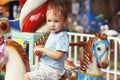 Cute little boy riding carousel Royalty Free Stock Photo