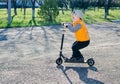 Cute little boy riding a scooter Royalty Free Stock Photo