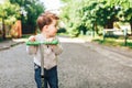 Pretty little boy riding scooter outdoor on the street Royalty Free Stock Photo