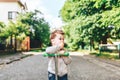 Pretty little boy riding scooter outdoor on the street Royalty Free Stock Photo