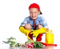 Cute little boy with scoop, fresh organic vegetables and watering can Royalty Free Stock Photo