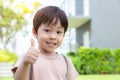 Cute little boy showing thumb up with smiley face. Lovely boy feel happy and relaxed. He has good health and enjoy life. Little Royalty Free Stock Photo