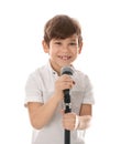 Cute little boy singing into microphone on white Royalty Free Stock Photo
