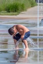 Boy sitting on a water fountain Royalty Free Stock Photo