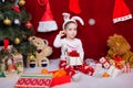 Cute little boy is sitting with a Christmas gift Royalty Free Stock Photo
