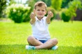 Cute little boy sitting on the grass Royalty Free Stock Photo