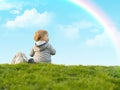 Cute little boy sitting on the green grass with a toy bunny Royalty Free Stock Photo