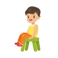 Cute little boy sitting on a small green stool, colorful character