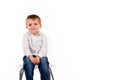 Cute little boy sitting on a stool Royalty Free Stock Photo