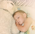 Cute little boy sleeping with his teddy bear Royalty Free Stock Photo