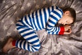 Cute little boy sleeps in pajames on bed. Fokus above