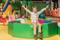 cute little boy smiling at camera while sister playing in pool with colorful balls Royalty Free Stock Photo