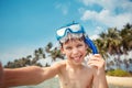 Cute little boy in snorkeling mask making selfie at tropical beach on exotic island Royalty Free Stock Photo