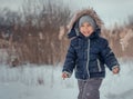 Cute little boy on a snowy field.