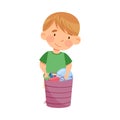 Cute Little Boy Standing Near Basket with Different Toys in Kindergarden Vector Illustration