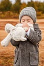 Little boy tenderly kisses his toy bunny with his eyes closed