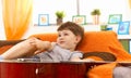 Cute little boy thinking on couch Royalty Free Stock Photo